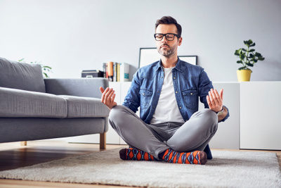 cropped-relaxed-man-meditating-at-home-946931302-5c16803846e0fb0001a669ae.jpg